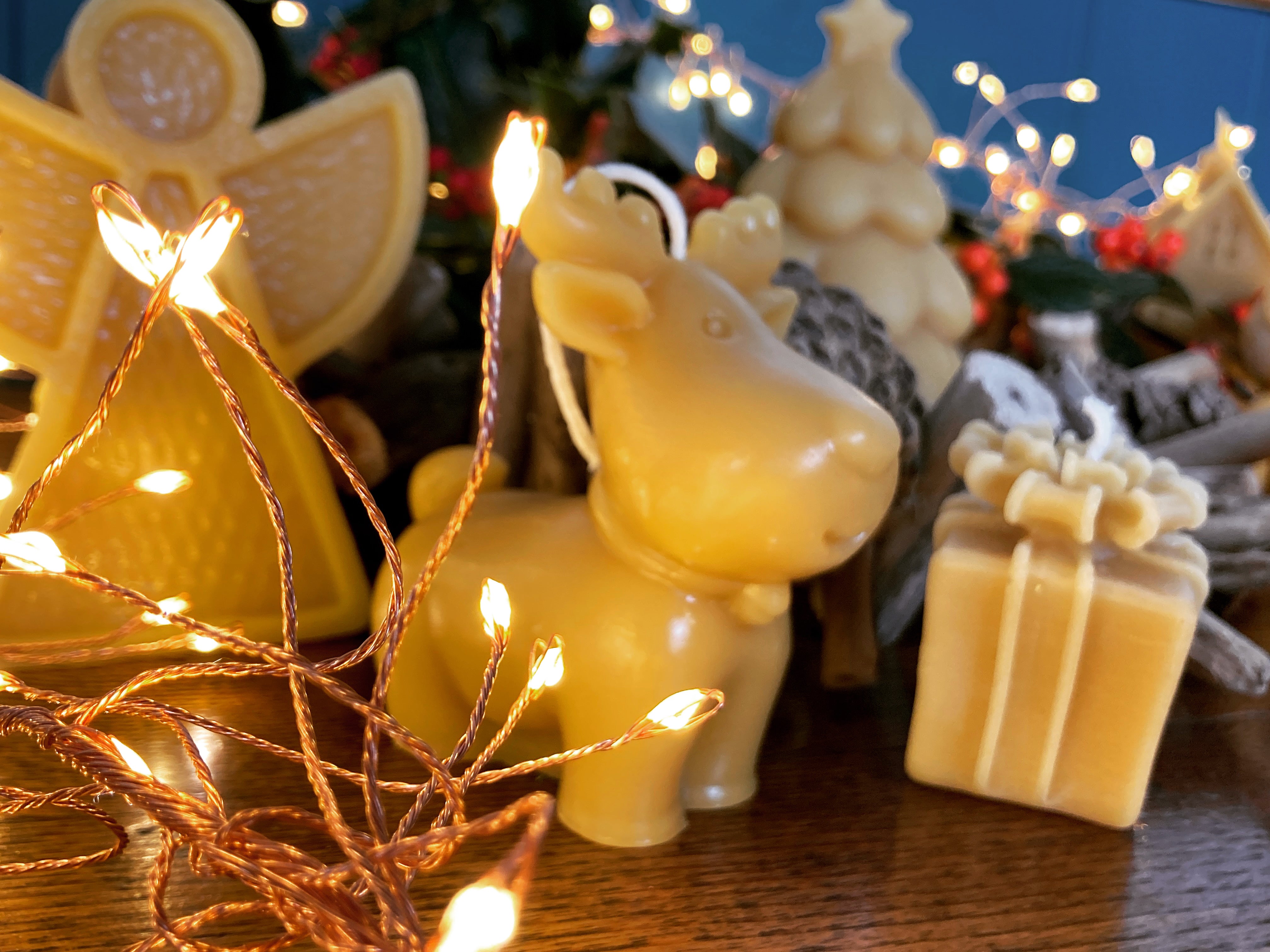 cute cartoon style reindeer candle in festive table decoration scene with lights