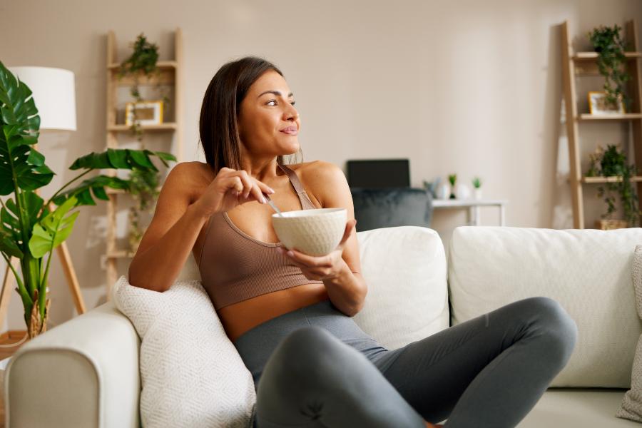 glamorous woman eating breakfast with black seed honey 